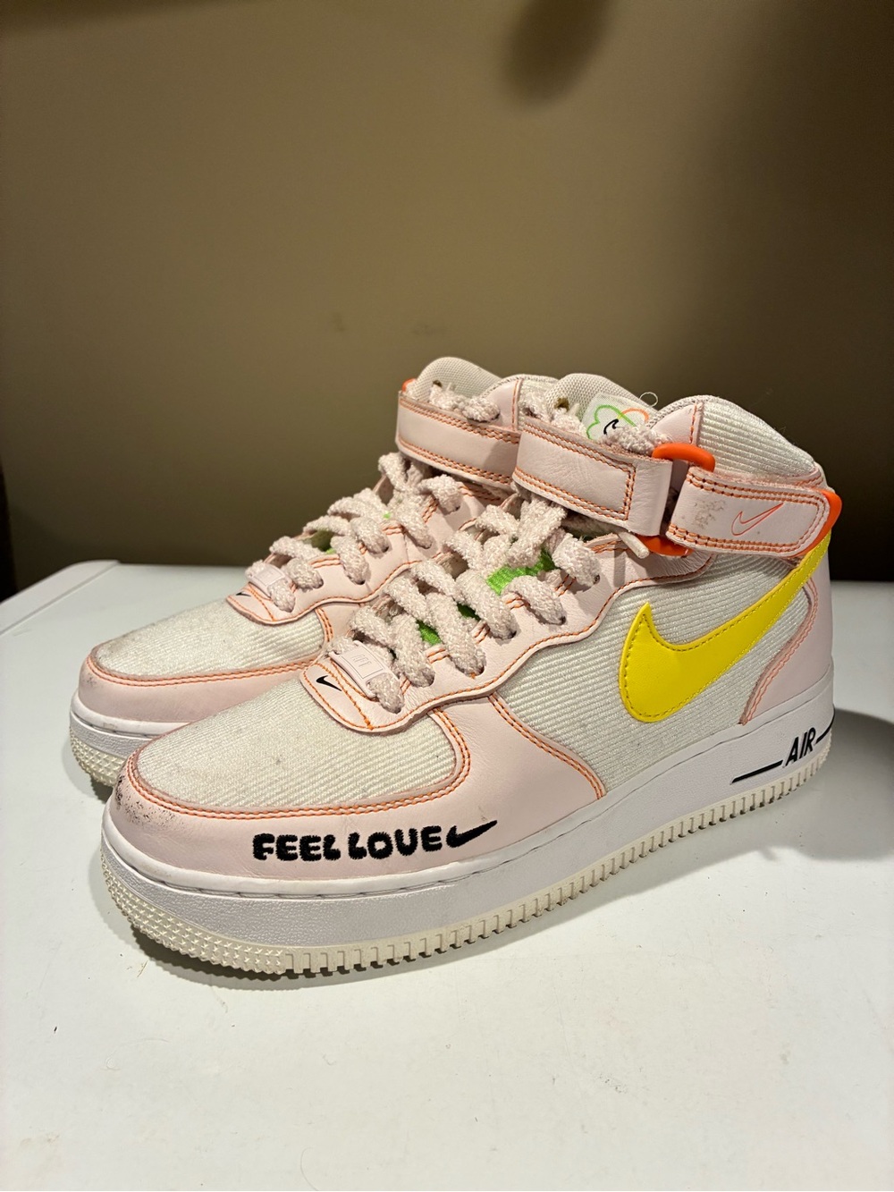 Nike Air Force 1 Feel Love Mid-Top Sneakers in Pale Pink with Yellow Swoosh